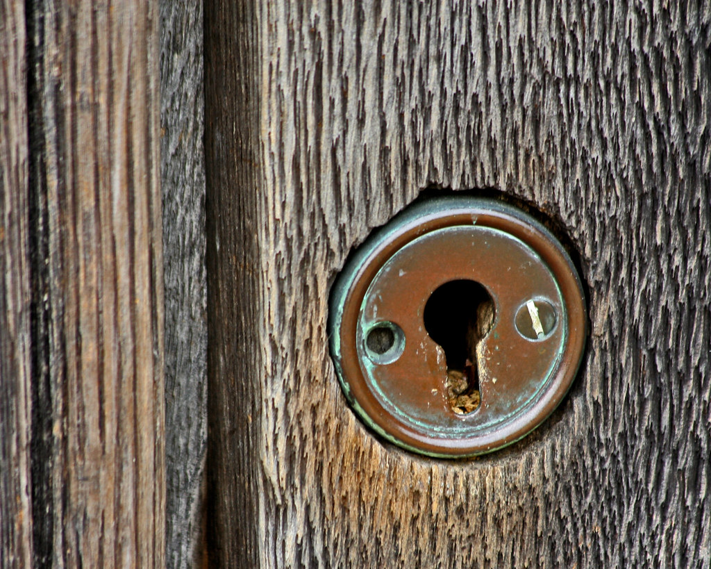 Close-up of a house front door and key, representing direct booking access